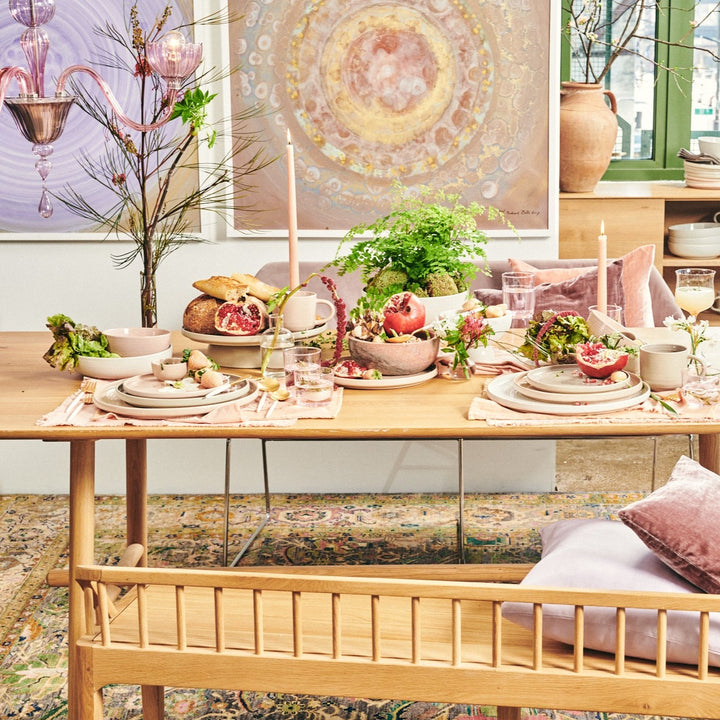 An invitingly decorated dining table exudes elegance and natural charm.