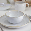 Minimalist and elegant ceramic dishes create a contemporary table setting.