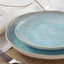 Artisanal ceramic plates with blue glaze and rustic charm.