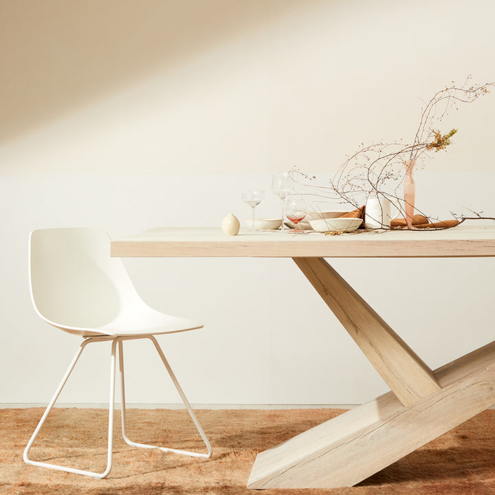 Minimalist dining setup with modern furniture and elegant decor elements.