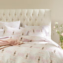 Cozy and elegant bedroom with tufted headboard and floral bedding.