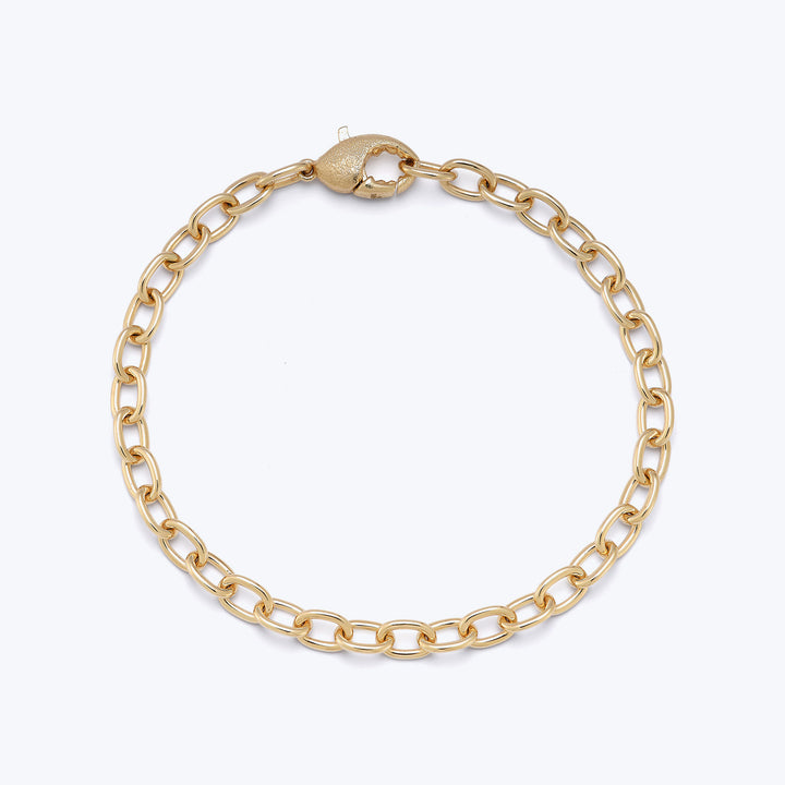 Gold-tone chain bracelet with interlocking links and clasp mechanism.