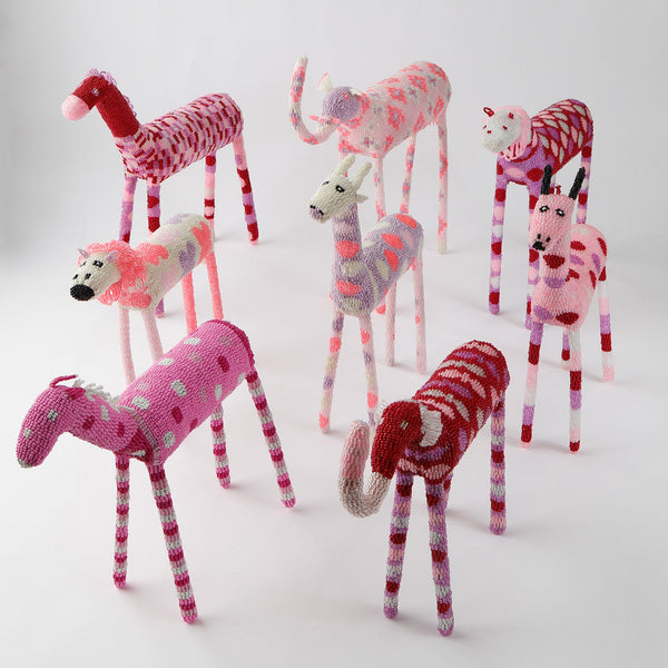 Whimsical knitted toy giraffes in vibrant colors and patterns.