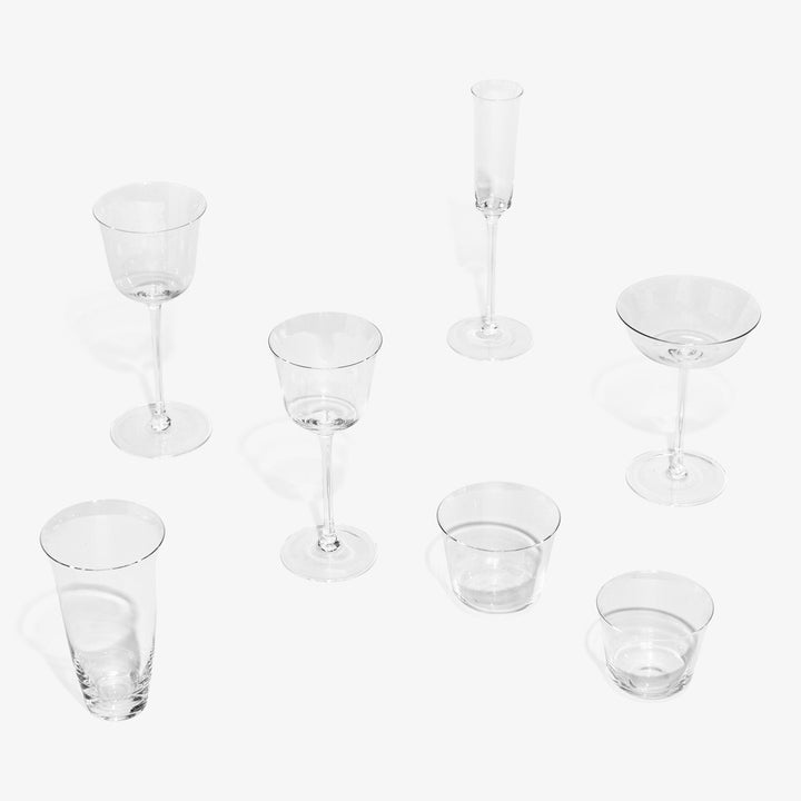 Collection of assorted glass cups and stemware on white background