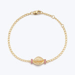 Gold bracelet with seashell design and pink gemstones, classic style