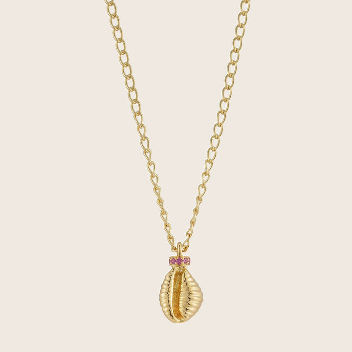 Gold necklace with sea shell pendant and pink gemstones
