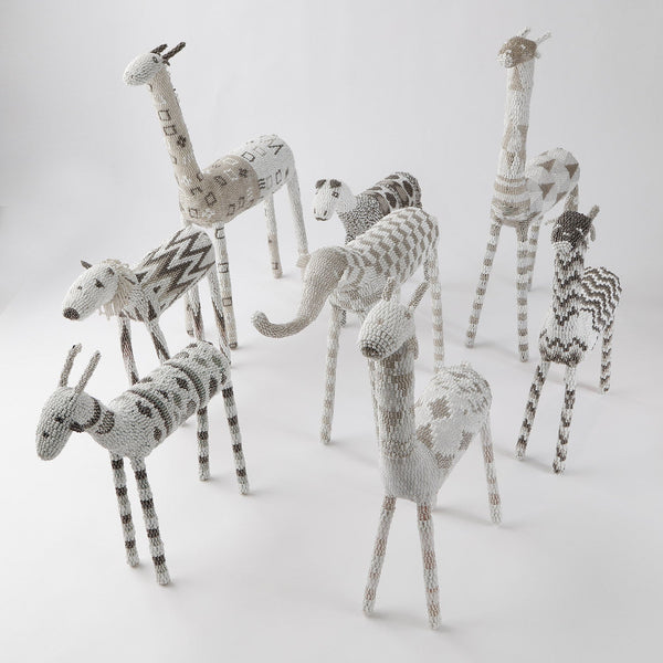 Handcrafted African wildlife figures in monochrome yarn, intricate designs displayed.